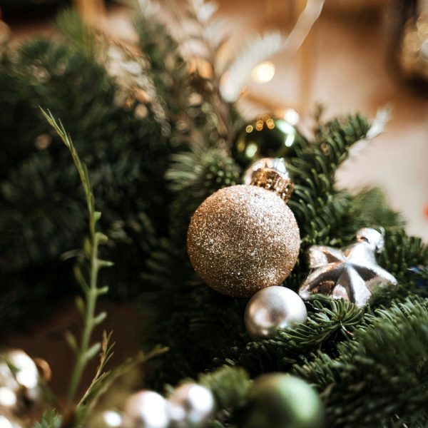 Christmas bauble on pine branch — calm, minimal holiday aesthetic for mindful routines article.