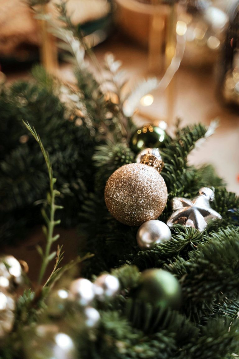 Christmas bauble on pine branch — calm, minimal holiday aesthetic for mindful routines article.