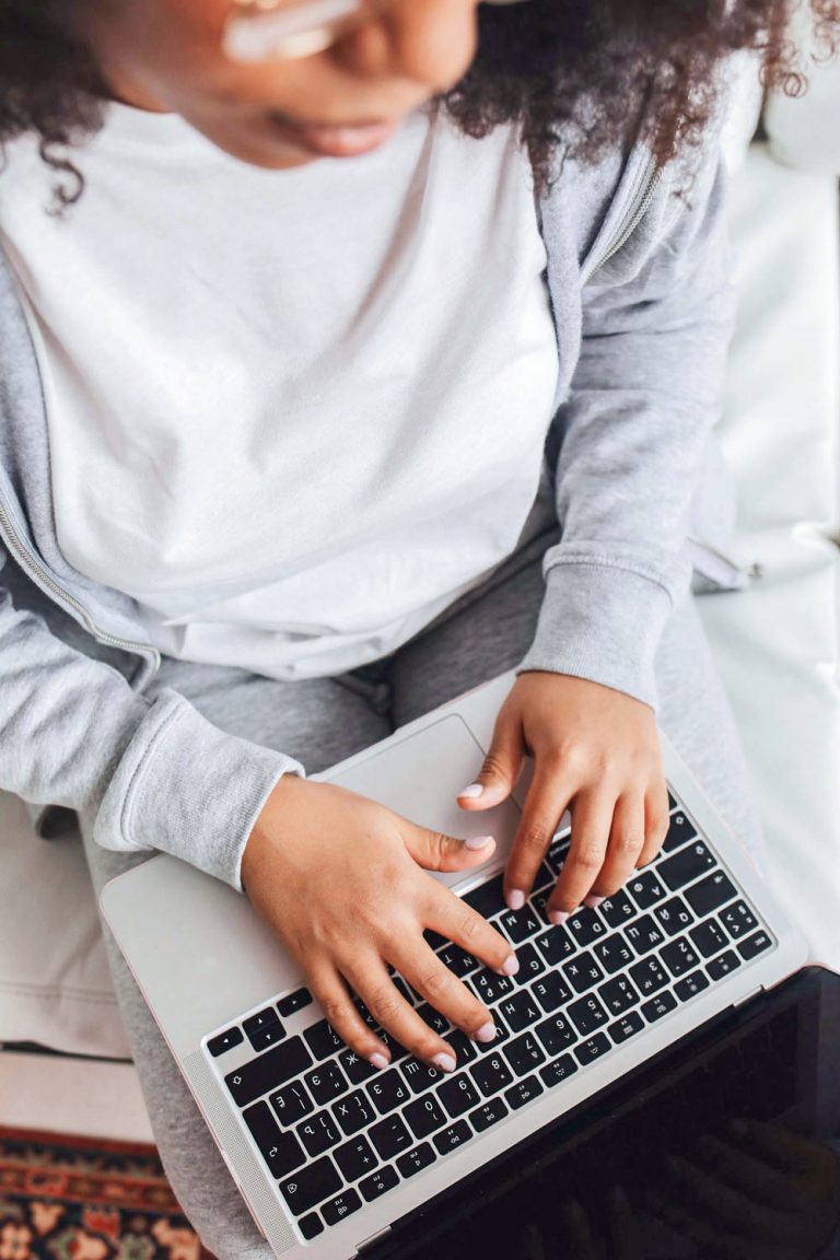 Online Visibility for Female-Led Brands: Why So Many Of Us Stay Unseen feature image woman dressed casually typing on laptop